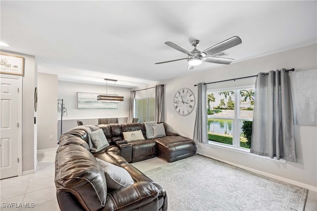 tiled living room with ceiling fan