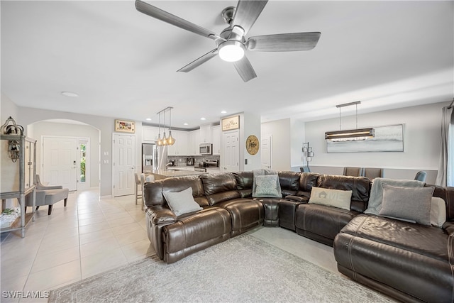 tiled living room with ceiling fan