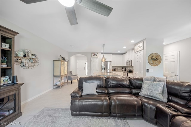 tiled living room featuring ceiling fan