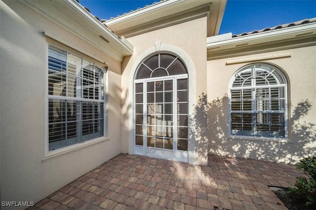 entrance to property featuring a patio area