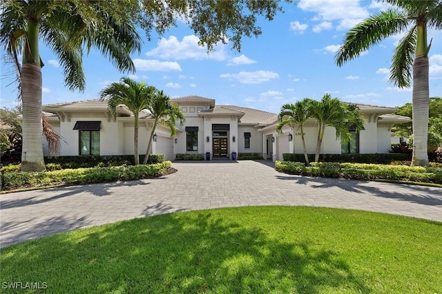 mediterranean / spanish house featuring a front lawn