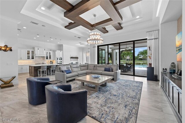 living room with coffered ceiling, a tray ceiling, crown molding, beam ceiling, and a notable chandelier