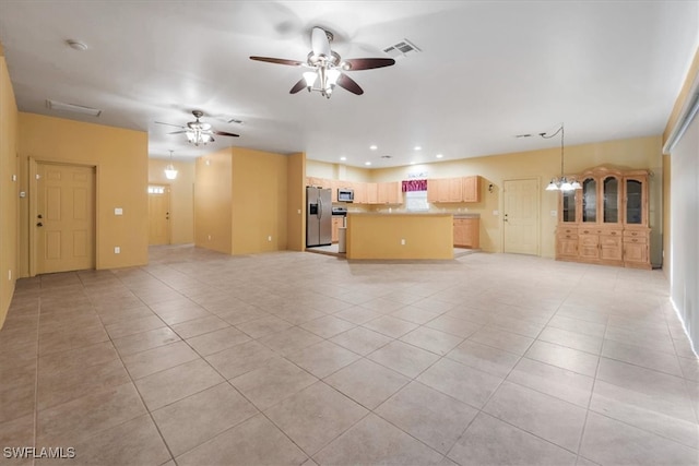 unfurnished living room featuring light tile patterned floors and ceiling fan with notable chandelier