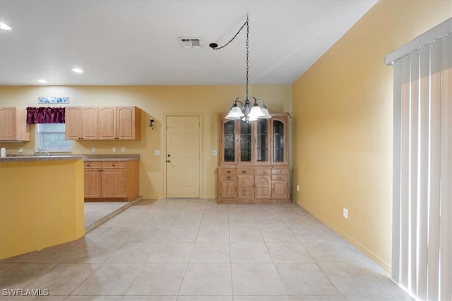 kitchen with decorative light fixtures, a chandelier, and light tile patterned flooring