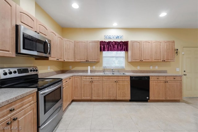 kitchen with sink, light brown cabinets, appliances with stainless steel finishes, and light tile patterned flooring