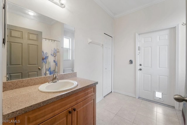 bathroom featuring ornamental molding, vanity, toilet, and tile patterned floors