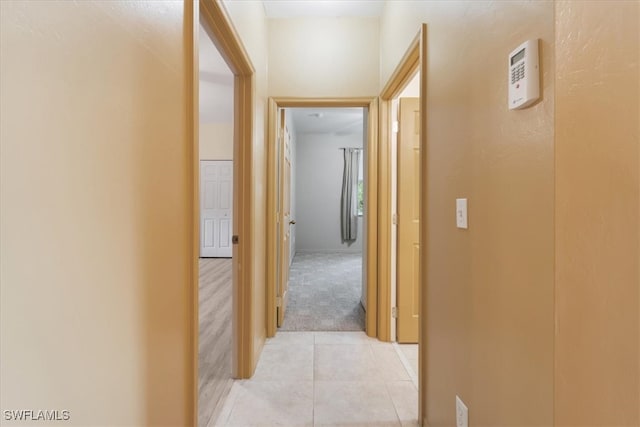 corridor featuring light tile patterned floors