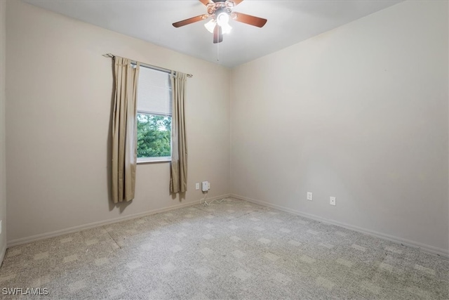 empty room with ceiling fan and light carpet