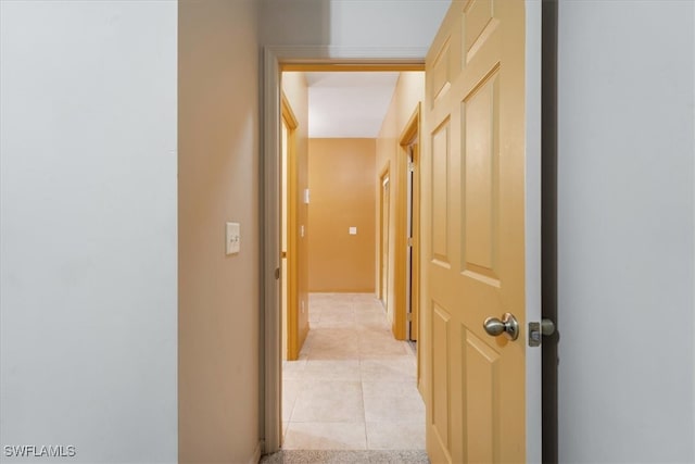 hall featuring light tile patterned flooring