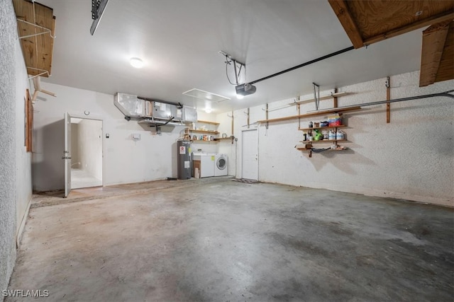 garage with electric water heater, independent washer and dryer, and a garage door opener