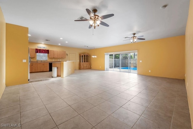 unfurnished living room with ceiling fan and light tile patterned floors