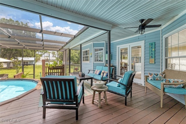 sunroom / solarium featuring ceiling fan