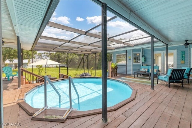 view of pool with a wooden deck, a lanai, and an outdoor hangout area