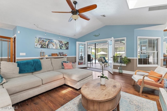 living room with ceiling fan, hardwood / wood-style flooring, and lofted ceiling