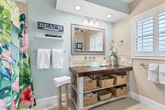 bathroom with tile patterned flooring, backsplash, and vanity