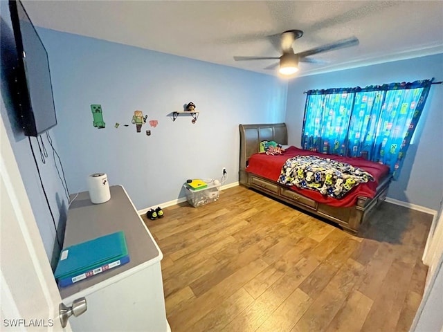 bedroom featuring ceiling fan and hardwood / wood-style floors