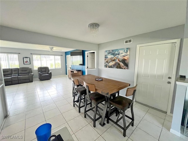 tiled dining area featuring ceiling fan