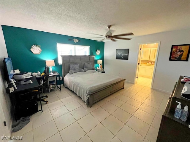 tiled bedroom with a textured ceiling, ensuite bath, and ceiling fan