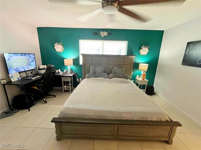 tiled bedroom with a textured ceiling and ceiling fan