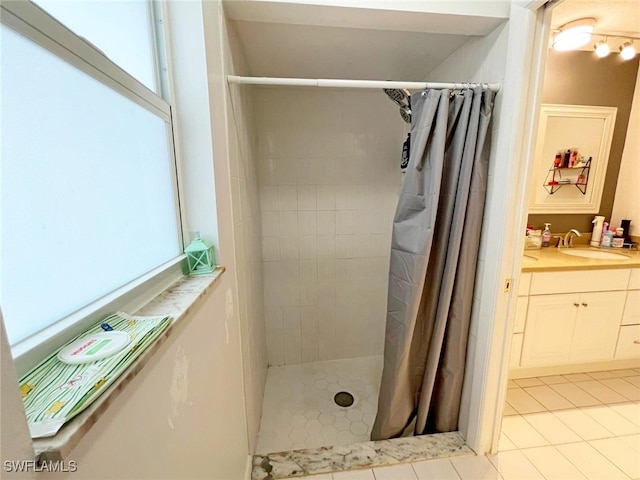 bathroom featuring vanity, tile patterned floors, and curtained shower