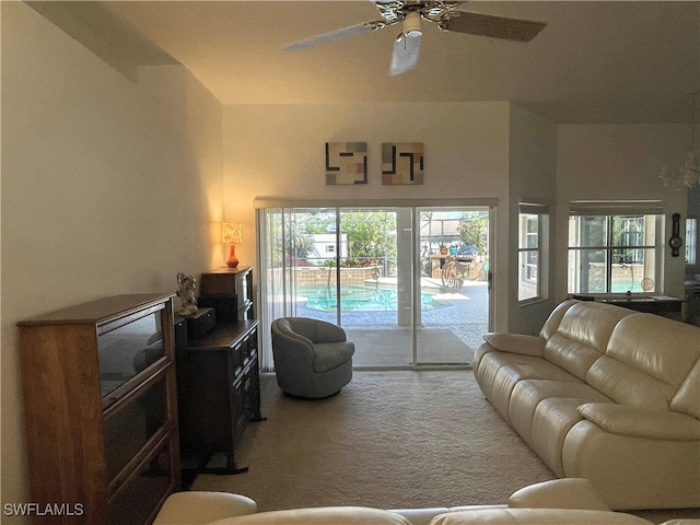 living room with ceiling fan and carpet