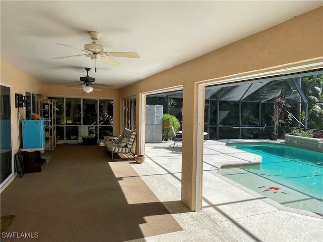 view of swimming pool featuring a lanai, ceiling fan, and a patio area