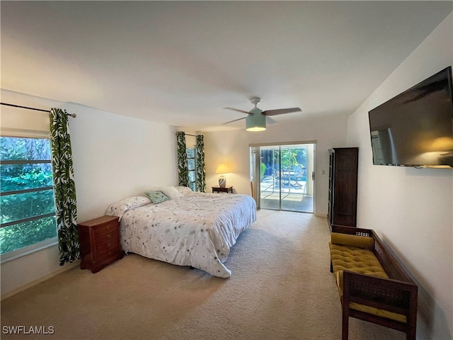 bedroom with vaulted ceiling, ceiling fan, access to exterior, and carpet floors