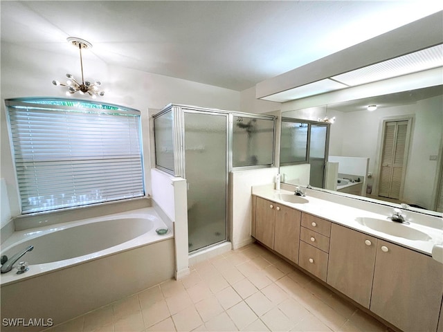 bathroom with a chandelier, independent shower and bath, vanity, and tile patterned floors