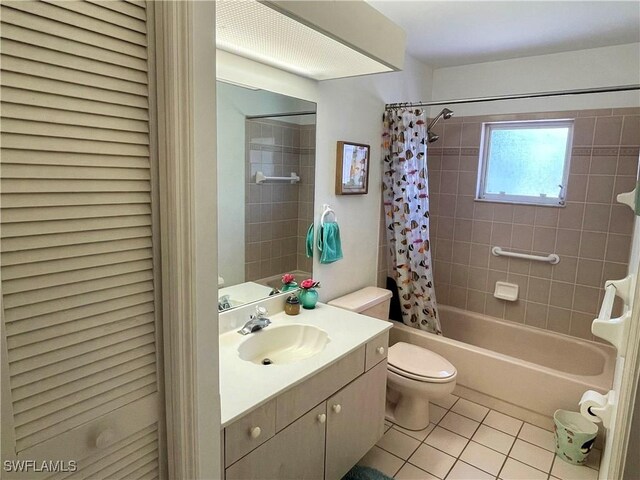 full bathroom with vanity, shower / tub combo with curtain, toilet, and tile patterned floors