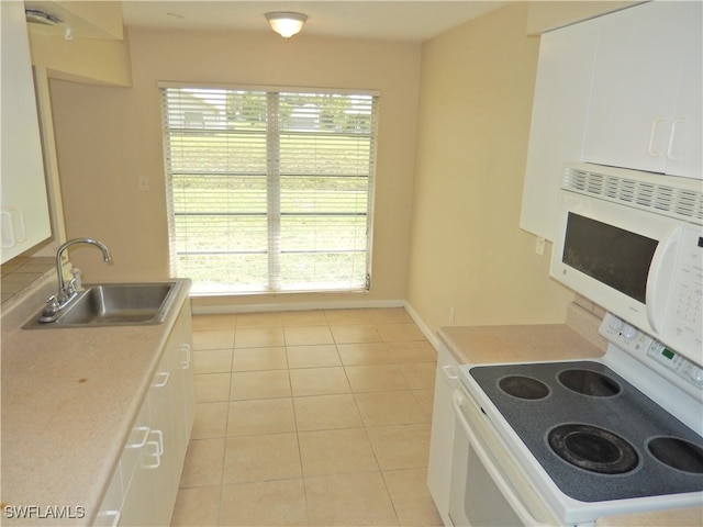 kitchen featuring sink, white appliances, light tile patterned flooring, and white cabinets