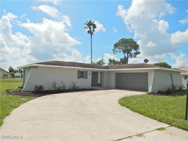 single story home featuring a front lawn and a garage