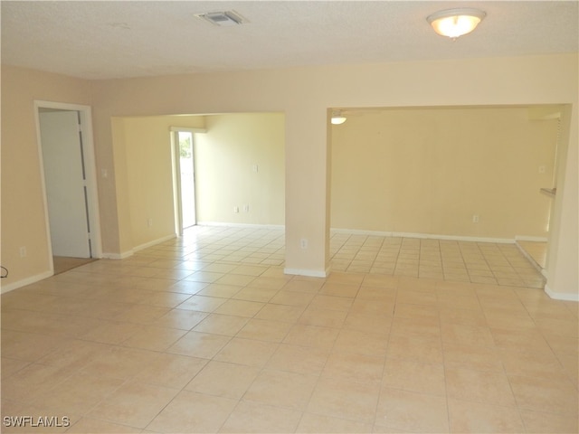 spare room featuring light tile patterned floors