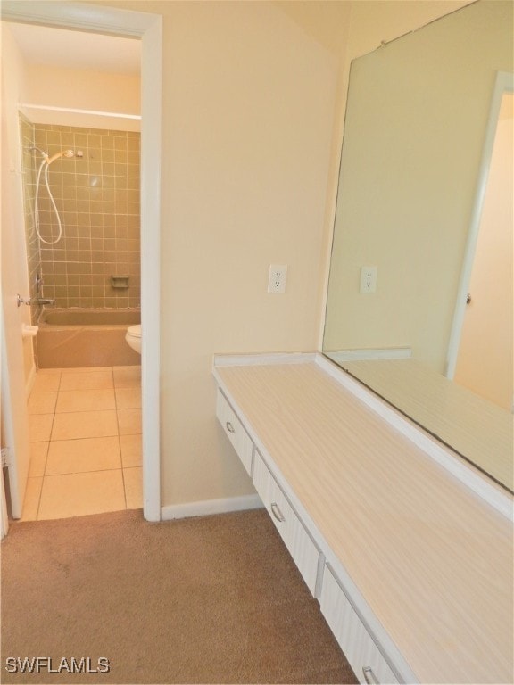 full bathroom with toilet, vanity, tile patterned floors, and tiled shower / bath