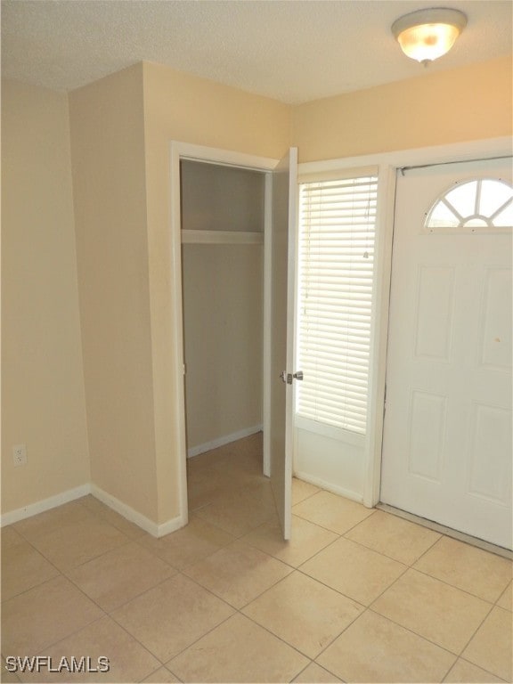 foyer featuring light tile patterned floors