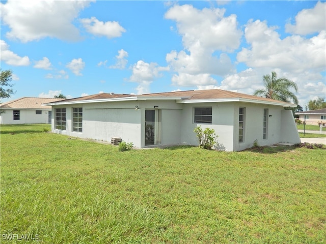 rear view of house with a yard