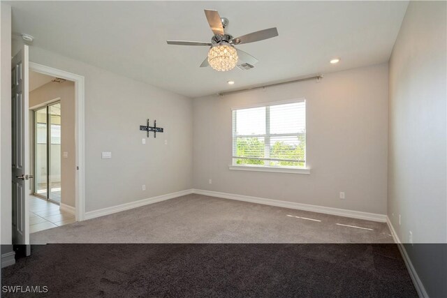 unfurnished room featuring ceiling fan and light carpet