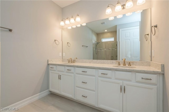 full bath with baseboards, double vanity, a sink, and a shower stall