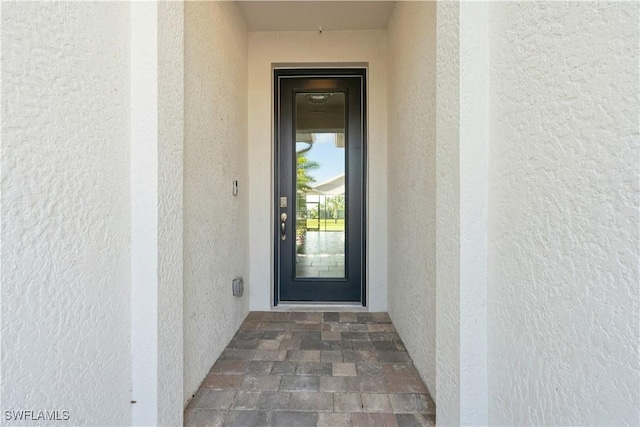 doorway to property with stucco siding