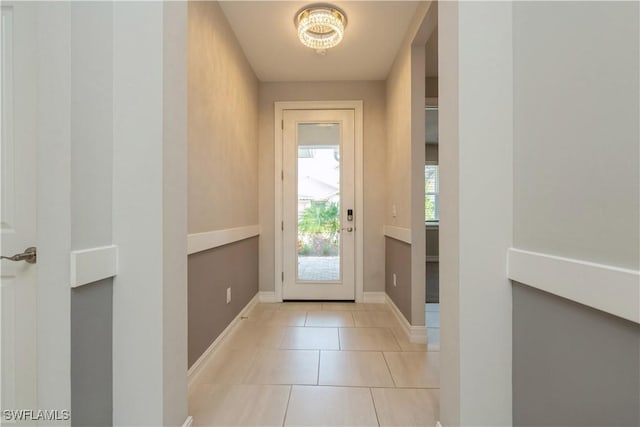 entryway with baseboards and tile patterned floors