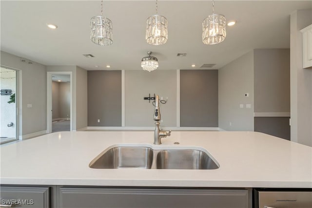 kitchen with open floor plan, light countertops, a sink, and recessed lighting