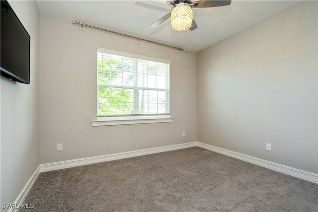 carpeted spare room featuring ceiling fan