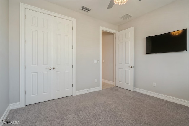 unfurnished bedroom featuring a closet, carpet flooring, and ceiling fan