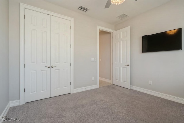 unfurnished bedroom with a closet, visible vents, baseboards, and carpet flooring