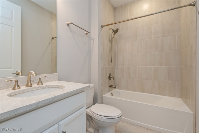 full bathroom featuring vanity, toilet, tiled shower / bath combo, and tile patterned floors