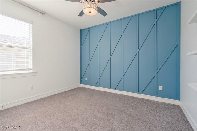 unfurnished room featuring plenty of natural light, ceiling fan, and carpet