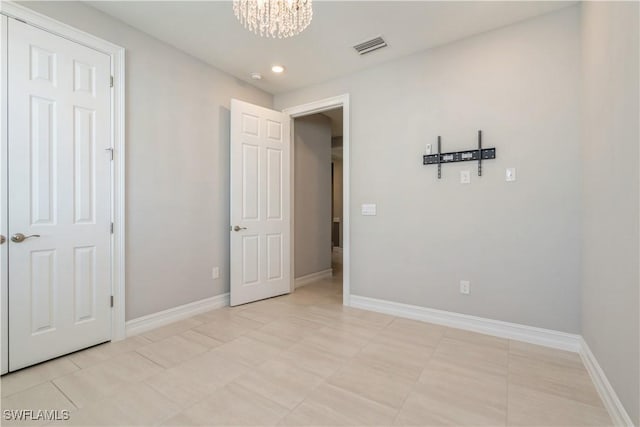 unfurnished bedroom featuring a chandelier, recessed lighting, visible vents, and baseboards