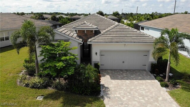 view of front of house with a garage and a front lawn