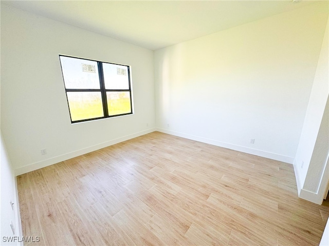 unfurnished room featuring light hardwood / wood-style floors