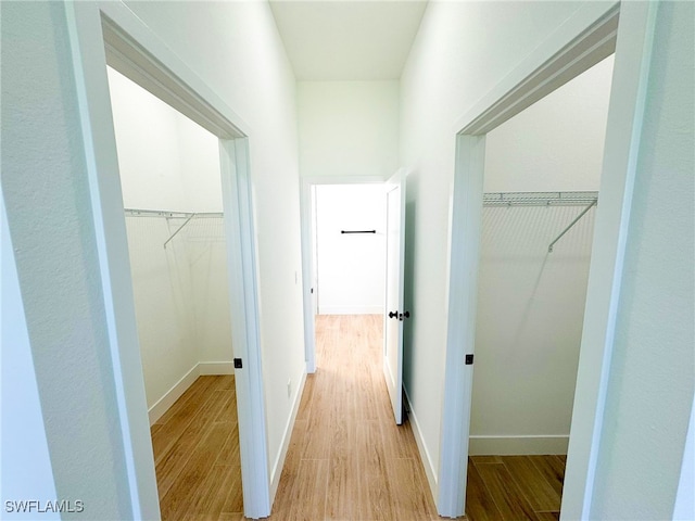 corridor with light wood-type flooring