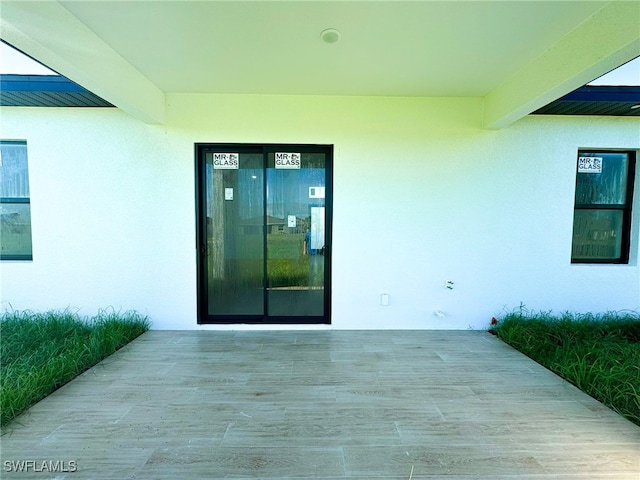 entrance to property with a patio